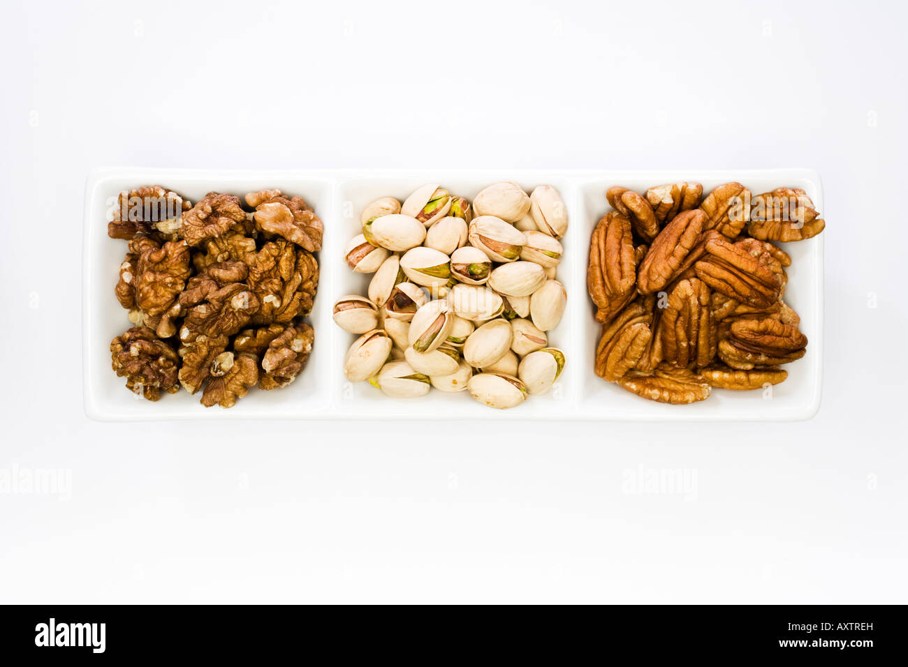 Three types of nut kernel Shelled Walnuts Pistachios and Pecans Stock Photo