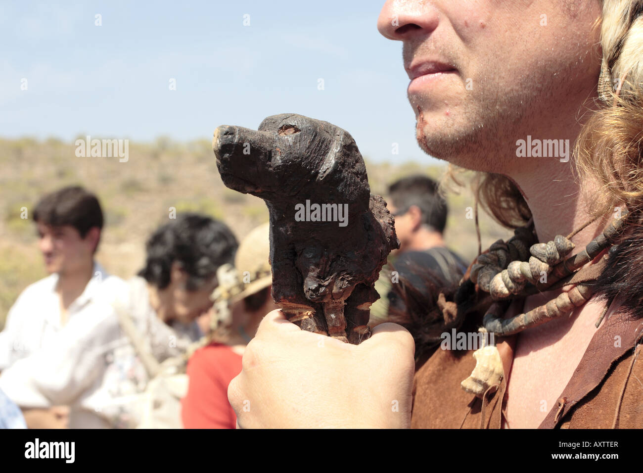 Man in Guanche dress holds a staff with a dogs head carved on it Guaza Tenerife Canary islands Spain Stock Photo