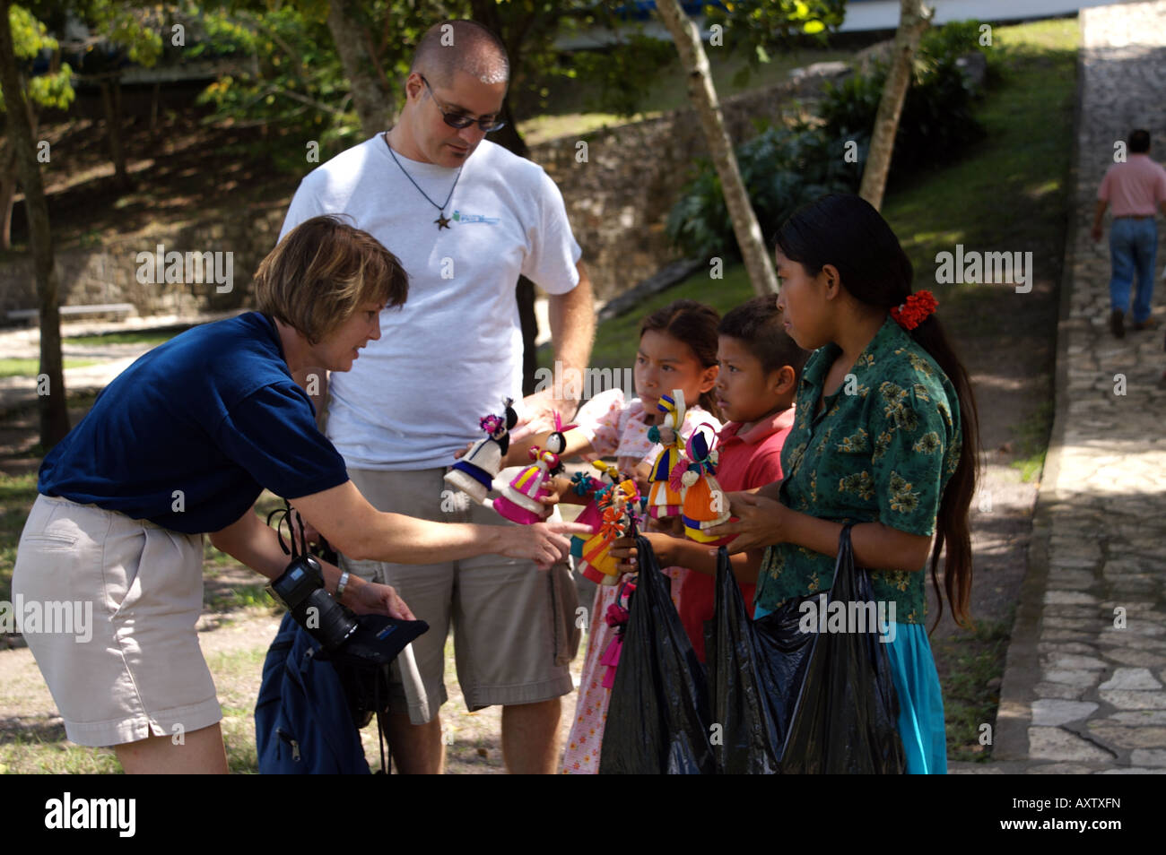 children selling straw dolls to tourists at Copan Ruins, Honduras Stock