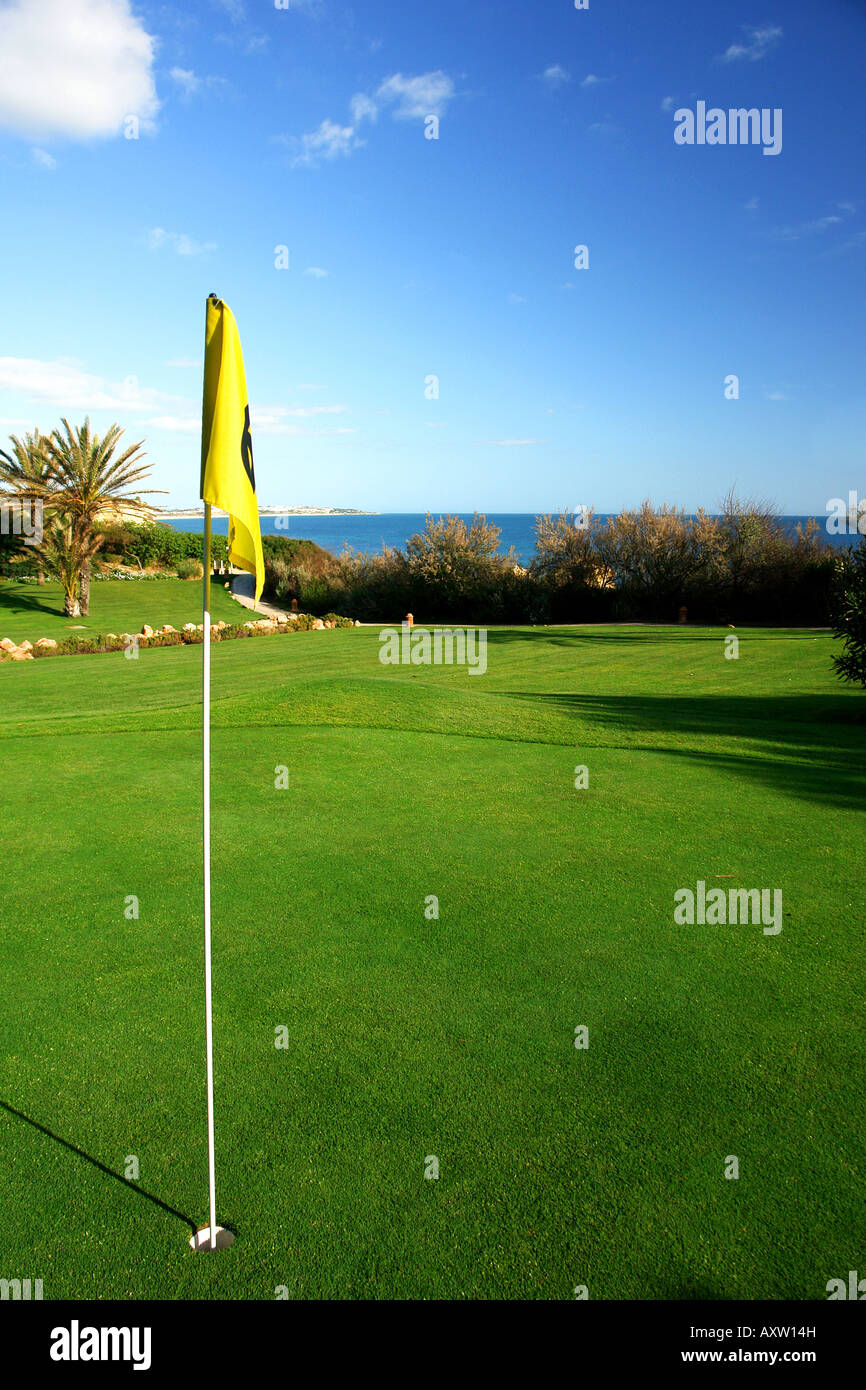 Flag on putting green in a golf course Stock Photo