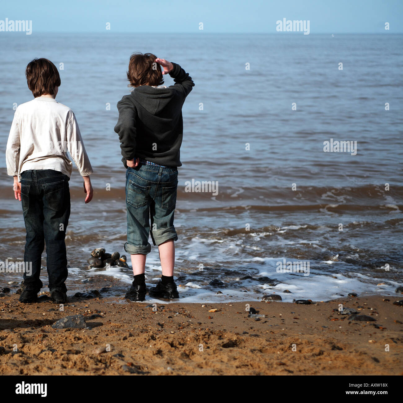 Two young boys (brothers) play at the seaside Stock Photo - Alamy