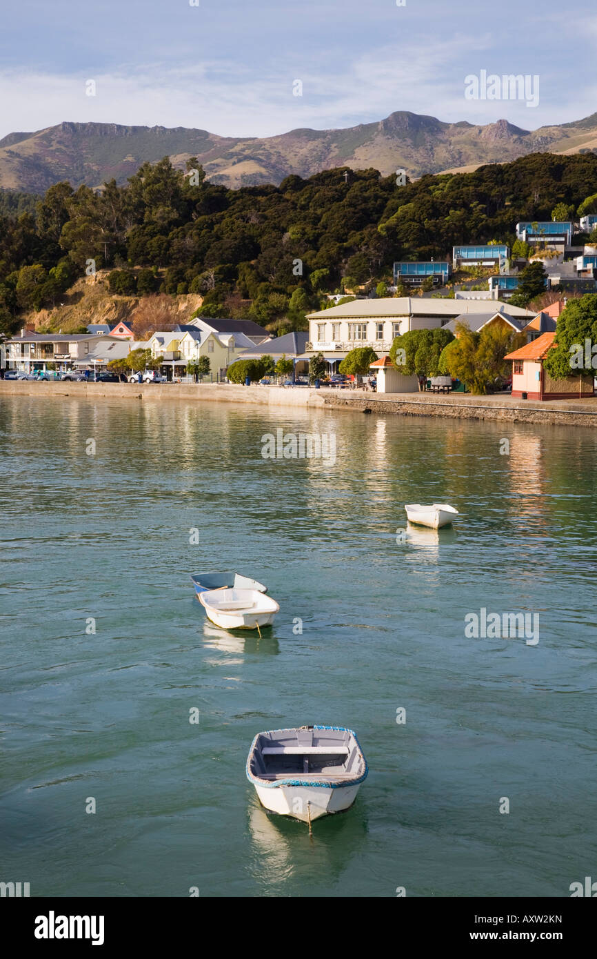 Akaroa across harbour in Bay with moored boats in picturesque town on 'Banks Peninsula' South Island New Zealand Stock Photo