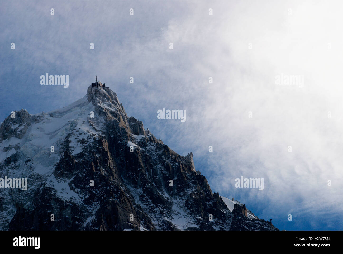 High winds and spectacular clouds over frozen needle of Aiguille du Midi (3842m), Chamonix-Mont Blanc, France Stock Photo