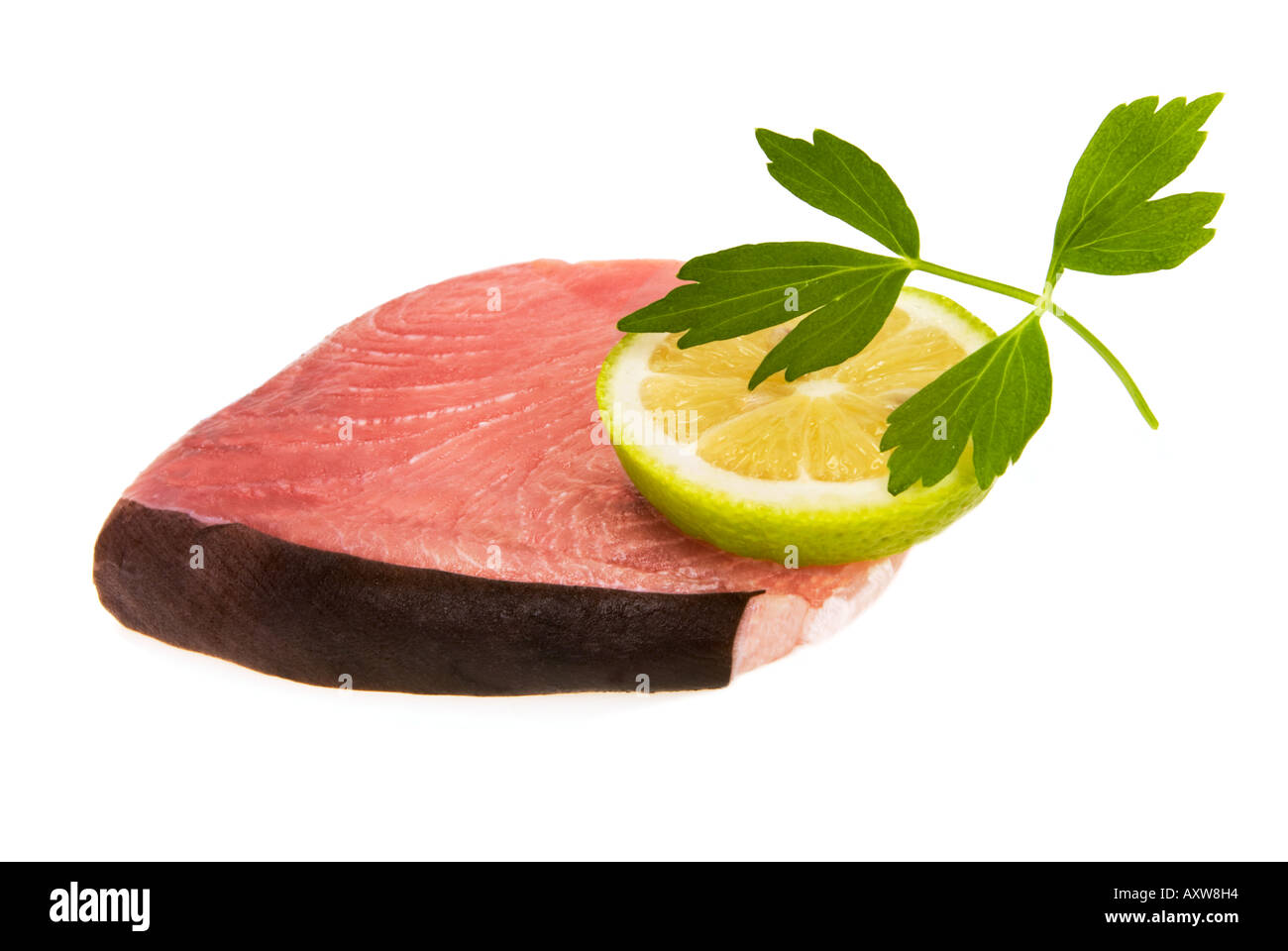 very fresh raw sword, fish, swordfish Xiphias gladius fillet steak cutlet cutout deco lemon pepper herb Stock Photo