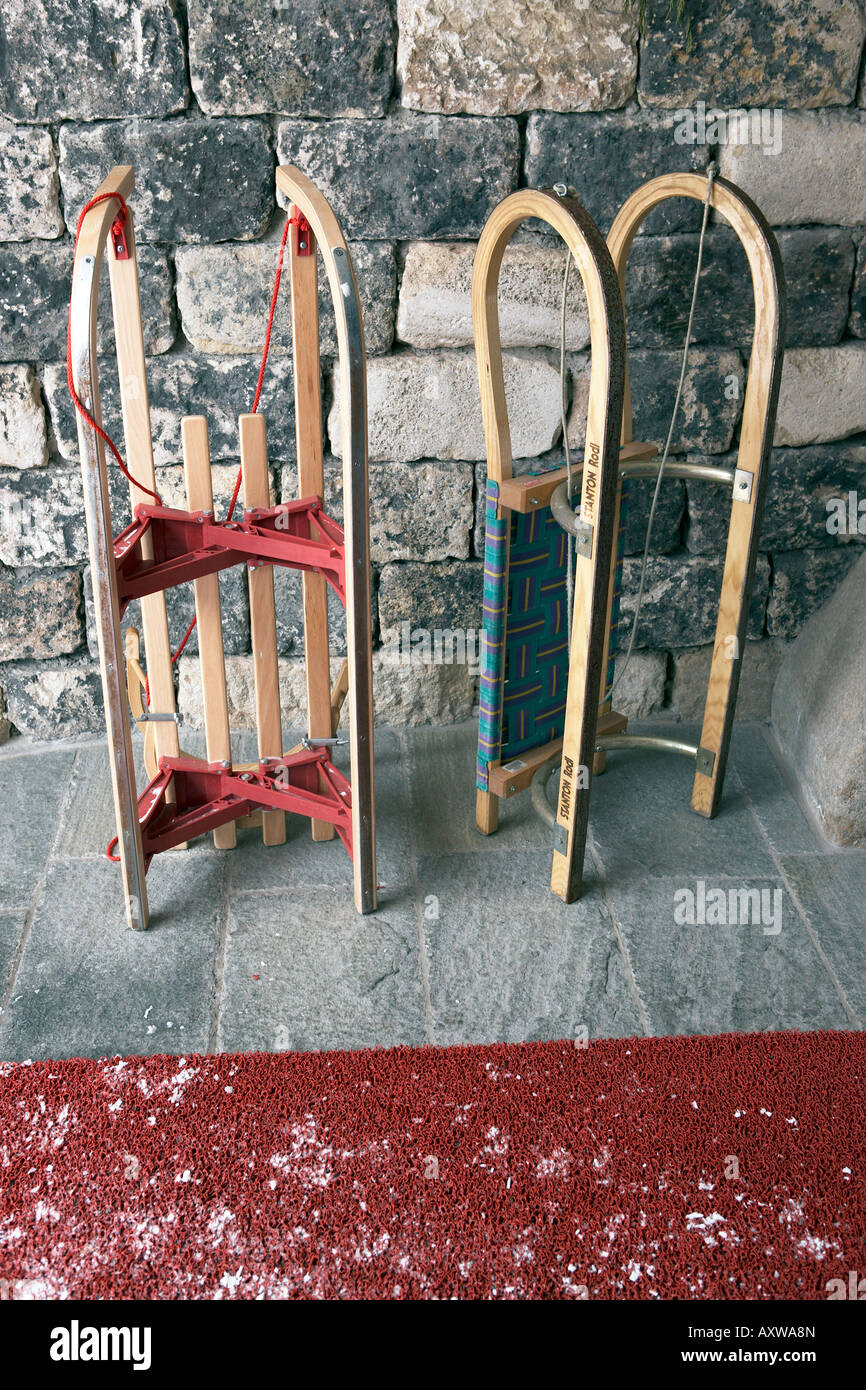 Snow sleds in doorway of Alpine hotel Stock Photo Alamy