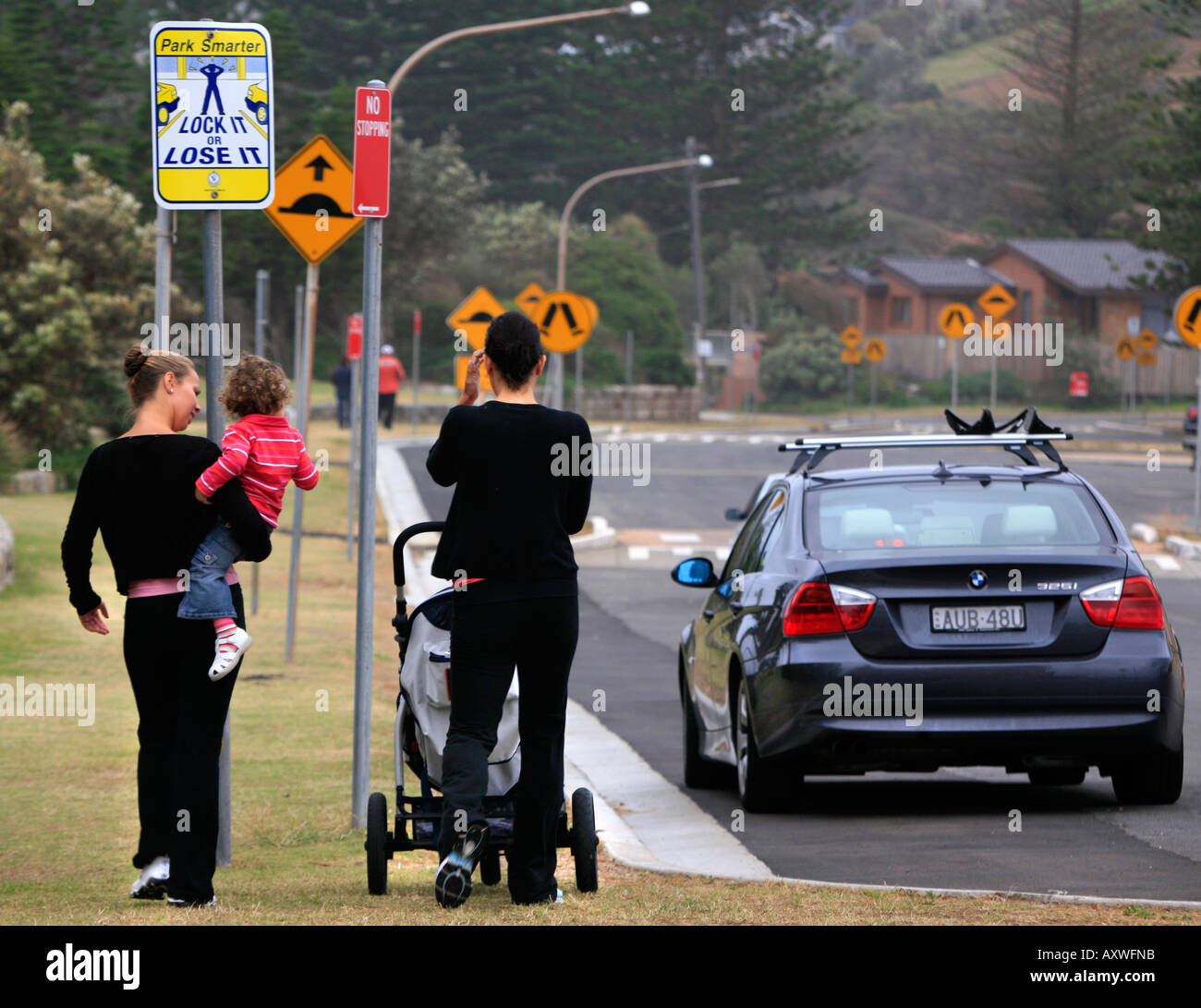 A sign warns drivers to lock their cars at an Australian beachside parking lot Stock Photo