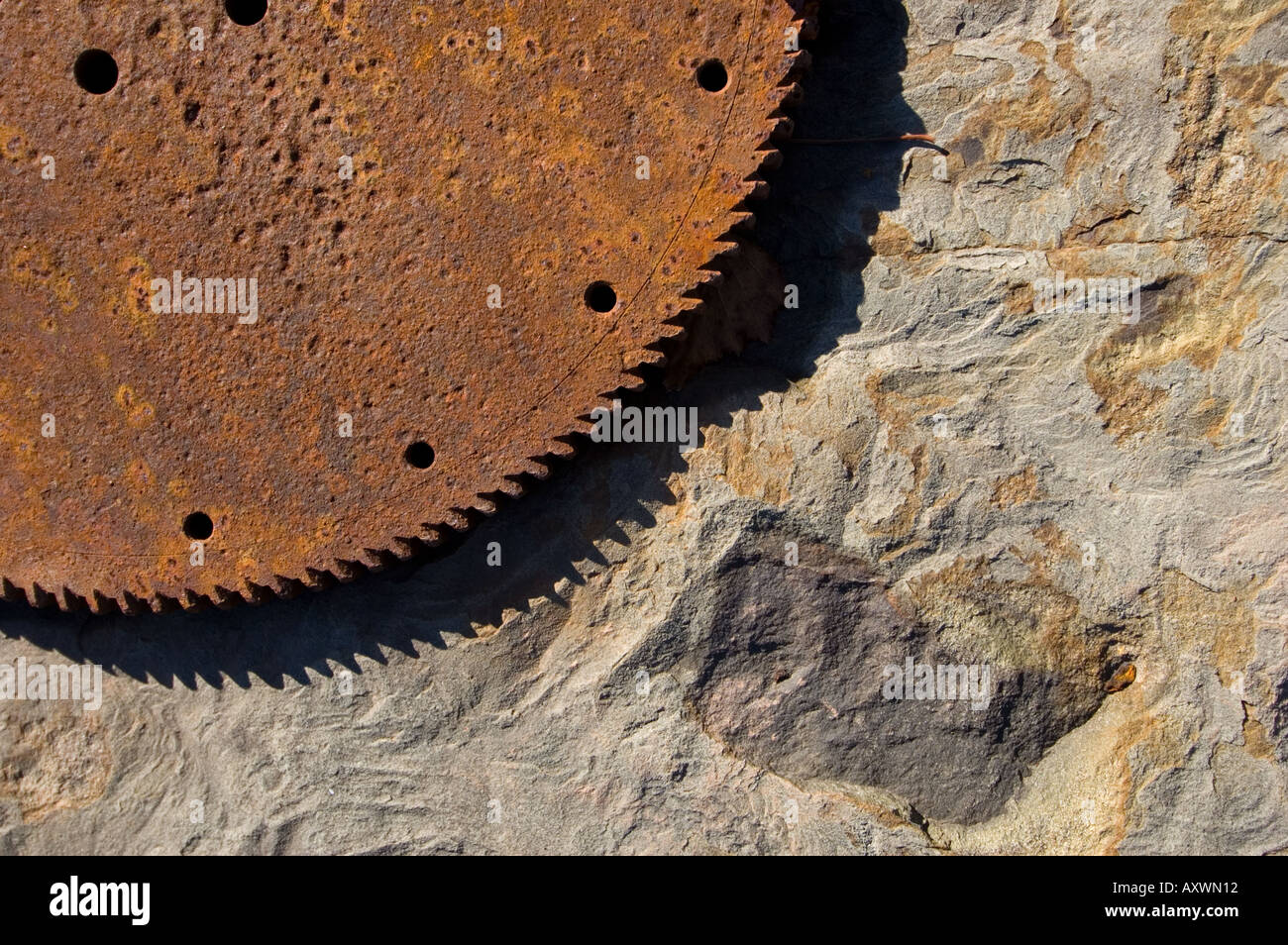 Old gear wheel laid against rough rock Stock Photo - Alamy