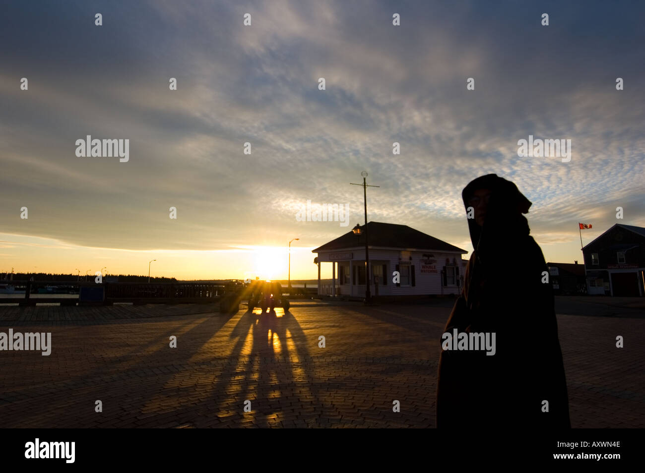 Hooded figure on the edge of the sea St Andrews New Brunswick Canada Stock Photo