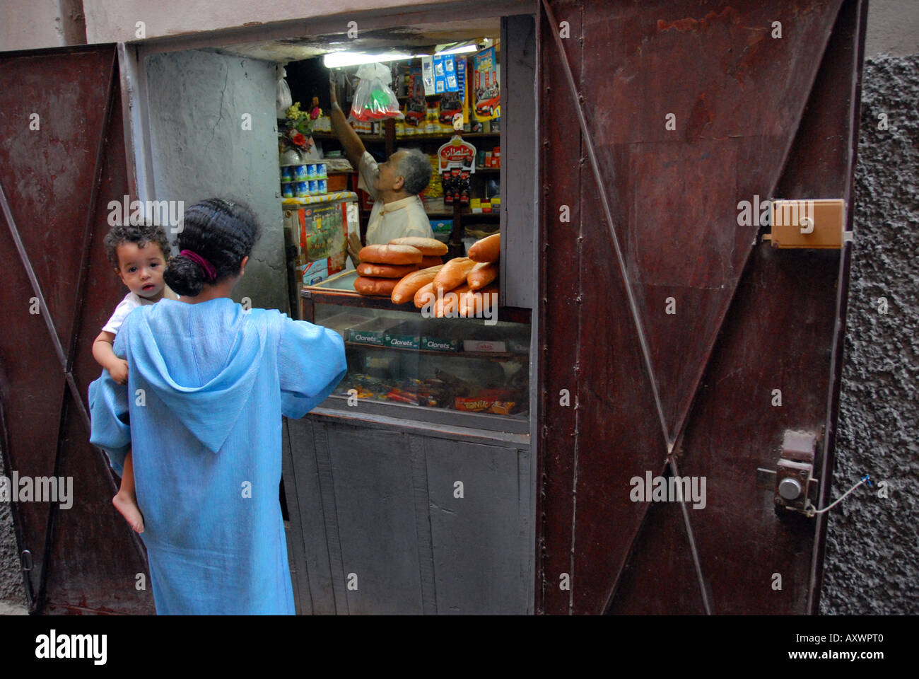 A tiny store in a hole in the wall in Marakech, Morroco sells bread and other simple items. Stock Photo