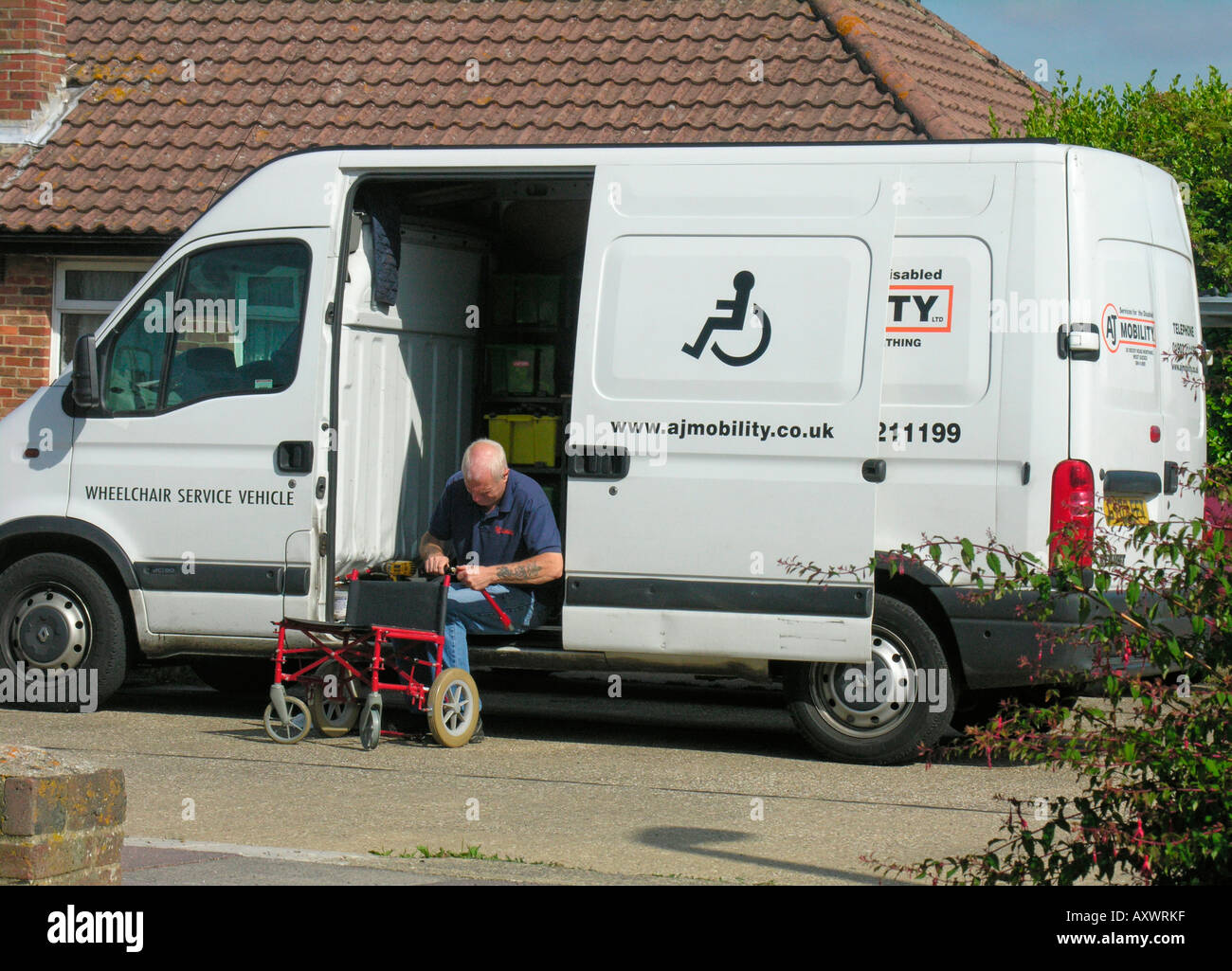 elderly man repairing and mending a wheelchair from a wheelchair