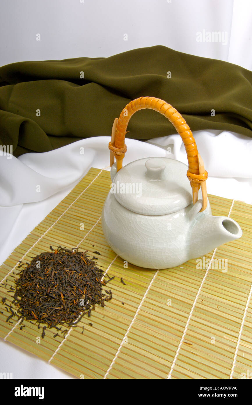 Green chinese teapot and tea leaves ready to serve tea Stock Photo Alamy