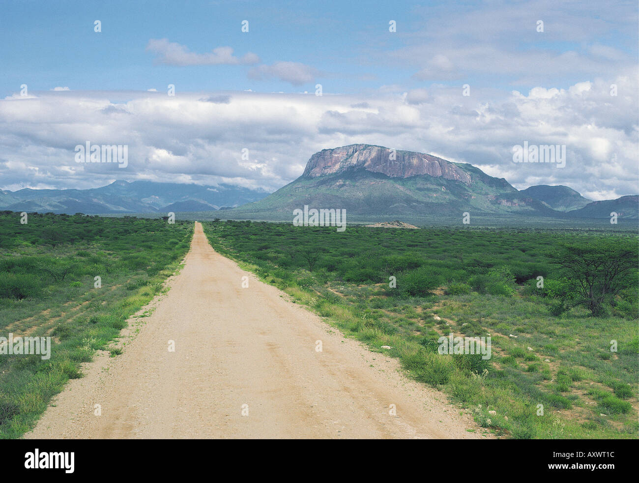 Road from Archers Post to Marsabit with Ololokwe ahead and Mathews Range to the left Northern Kenya East Africa Stock Photo