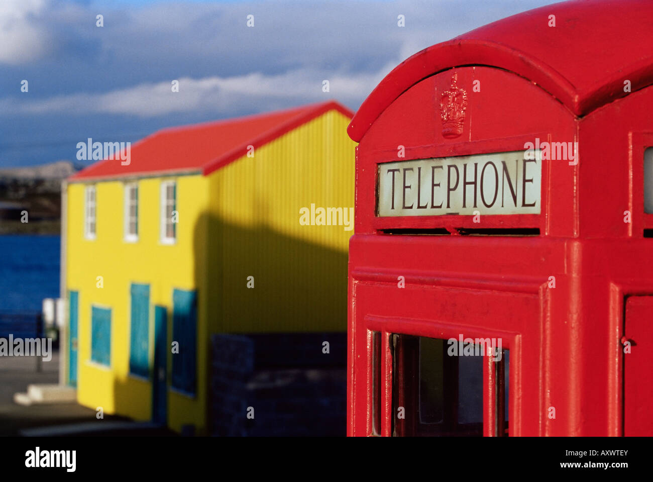 British red telephone box and colourful traditional house, Stanley, East Falkland, Falkland Islands, South Atlantic Stock Photo