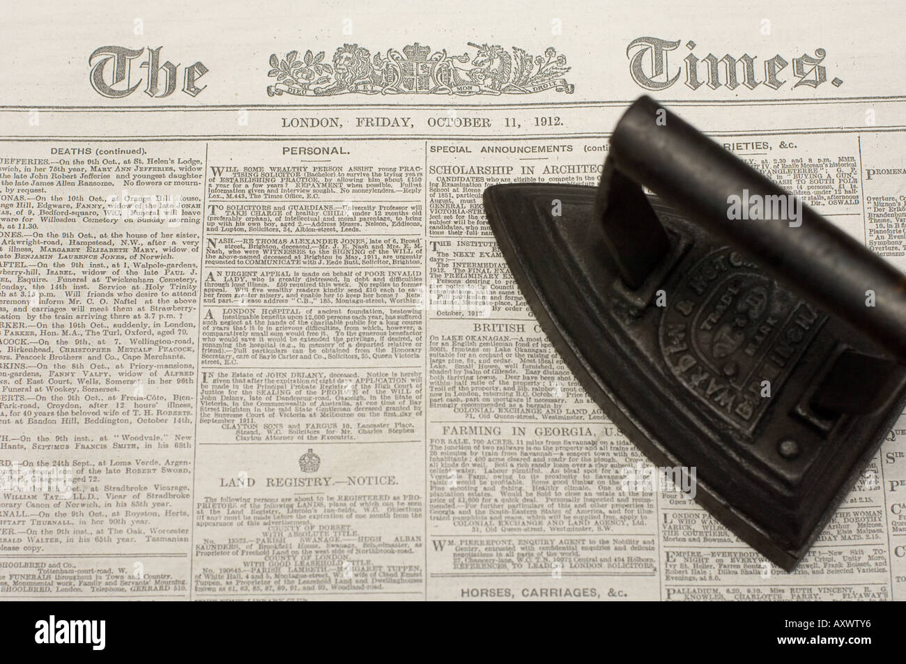 old fashioned iron lying on old copy of The Times newspaper newton