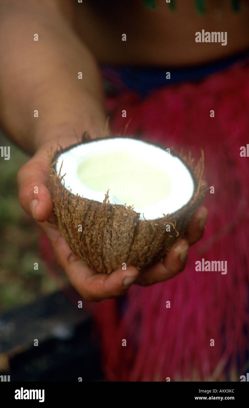 A refreshing coconut drink is offered to visitors to the Tiki Theatre Village in