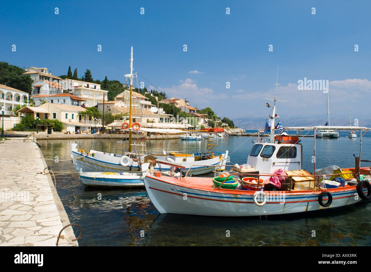 Fishing boats in the harbour in Kassiopi on the northeast coast of Corfu, Ionian Islands, Greek Islands, Greece, Europe Stock Photo