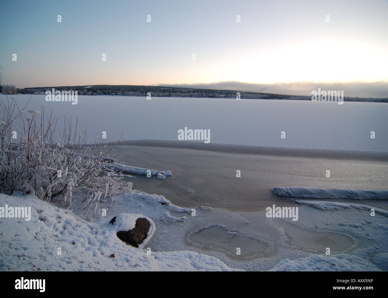 A freezing cold winter sunrise by Kemijoki river in central Rovaniemi, Finnish Lappland Stock Photo