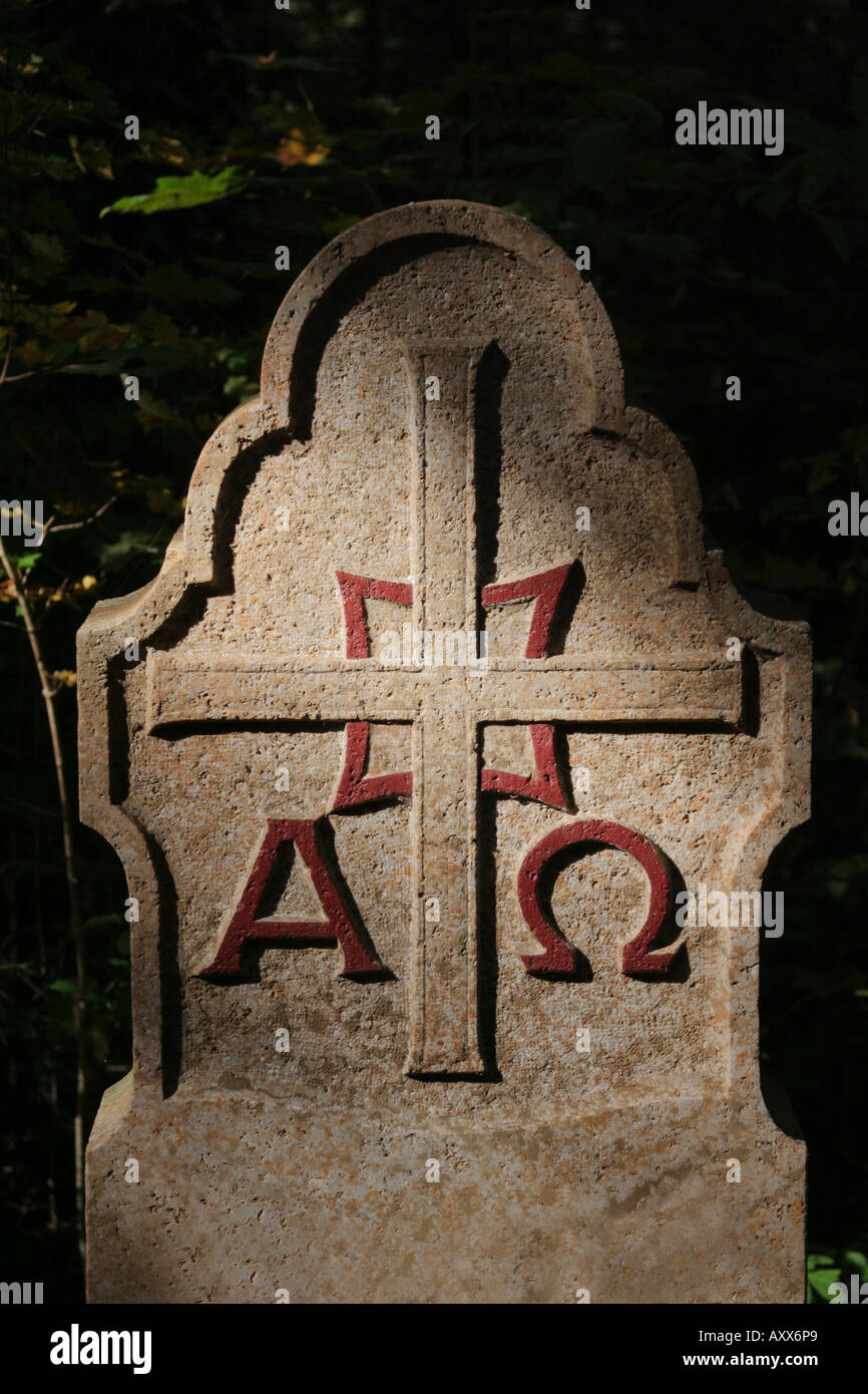 Alpha and Omega engraving and cross on a tombstone Stock Photo