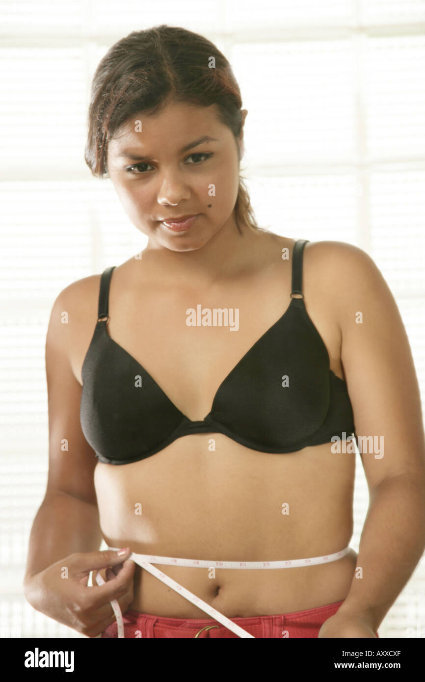 Young girl measures her waist. Stock Photo