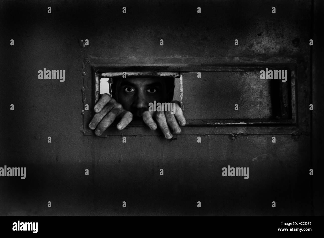 INMATE LOOKING OUT FROM HIS CELL WINDOW, SINOP PRISON,TURKEY , 06/03/2005 Stock Photo