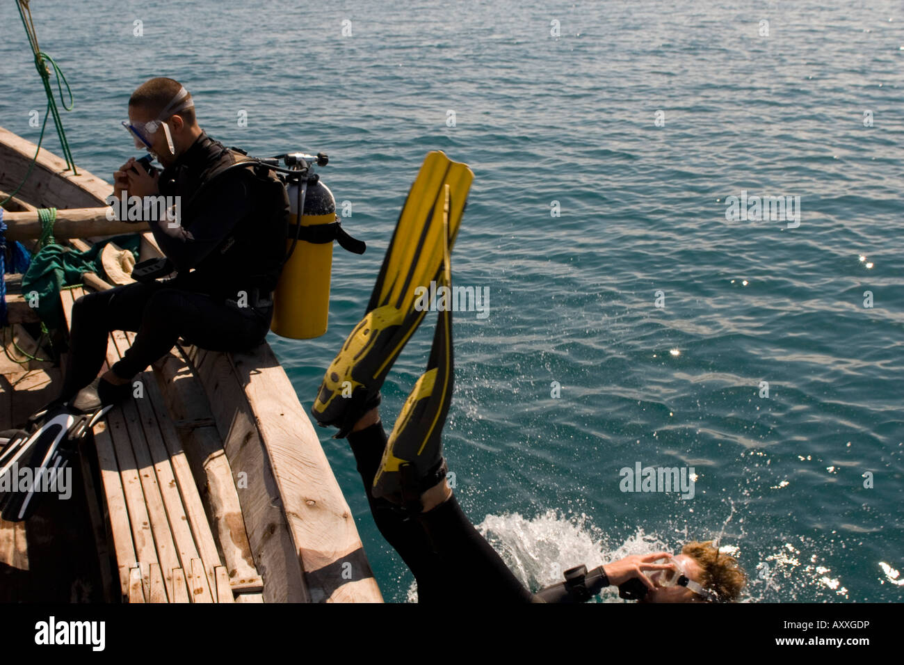 Scuba divers entering water from boat Chole Bay off Mafia Island