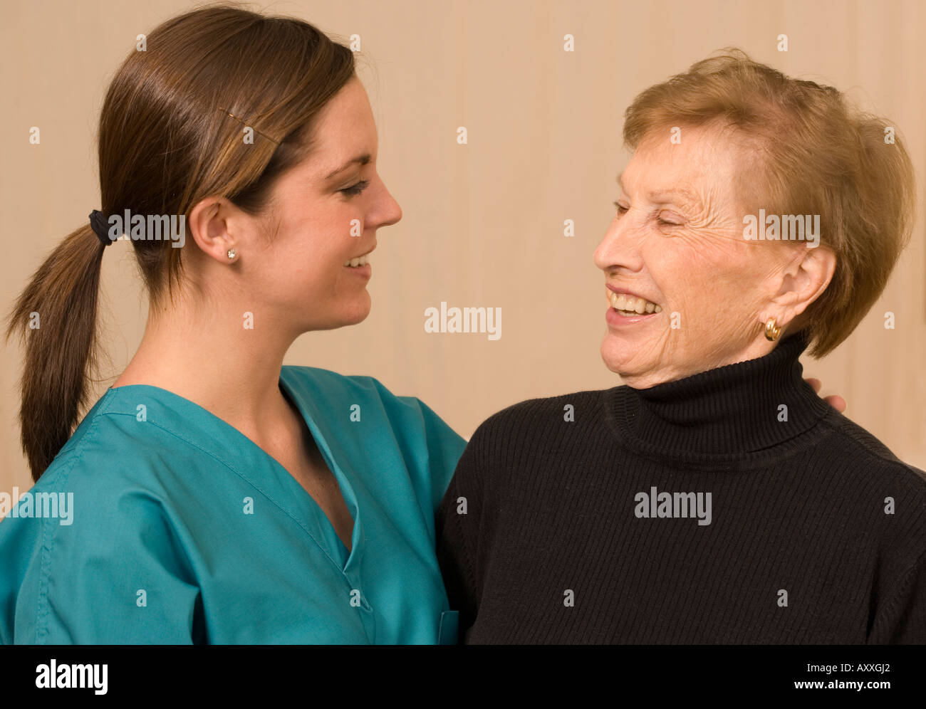 Nurse and patient talk and smile together. Stock Photo