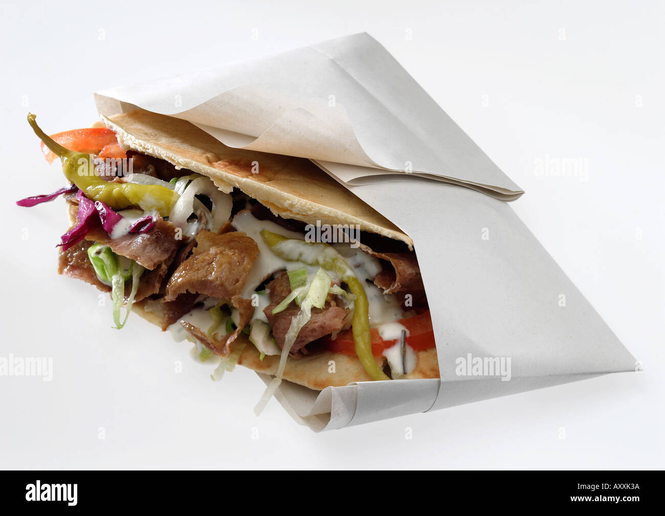 Doner kebab with salad and chilli in pitta bread and paper Stock Photo