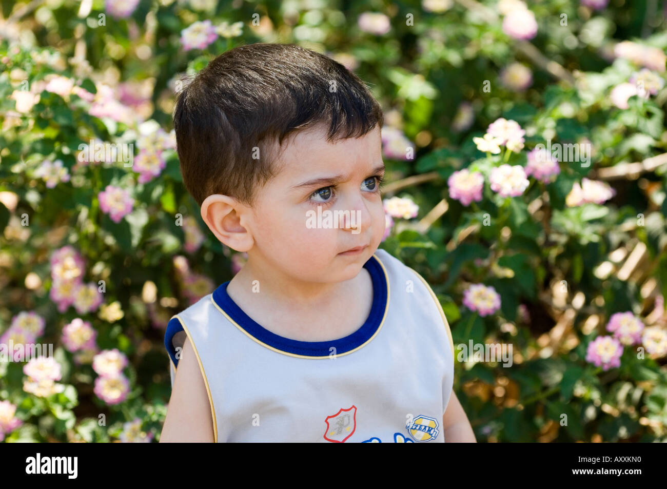 3 years old grumpy in the park looking away Stock Photo