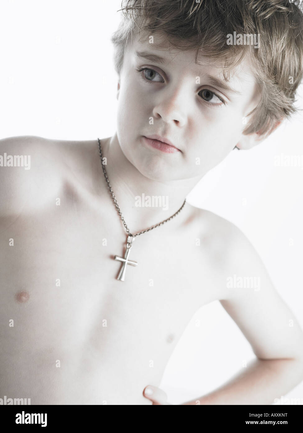 boy wearing chain with cross hanging on it Stock Photo Alamy