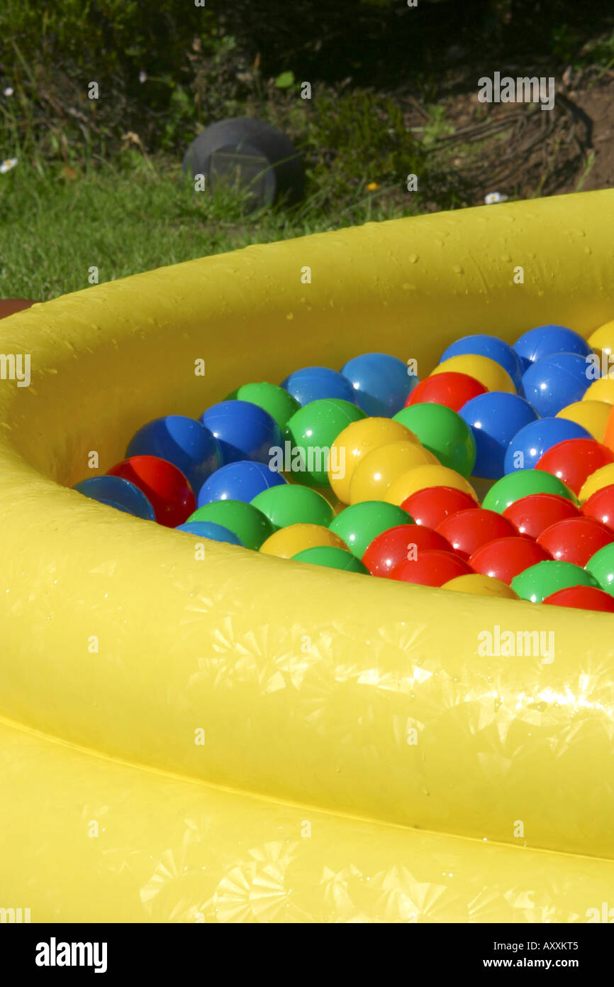 Brightly coloured play balls floating in paddling pool Stock Photo Alamy