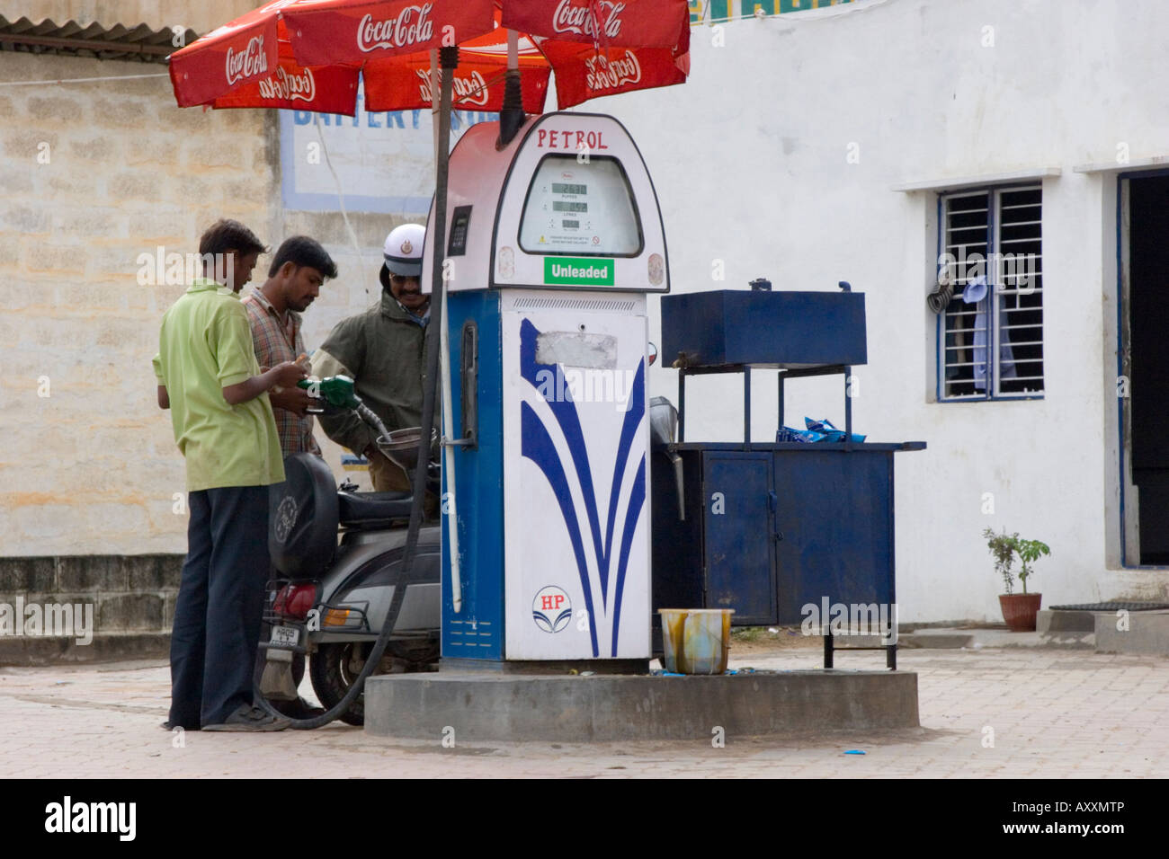 Moped filling up at a petrol station garage forecourt in Bangalore