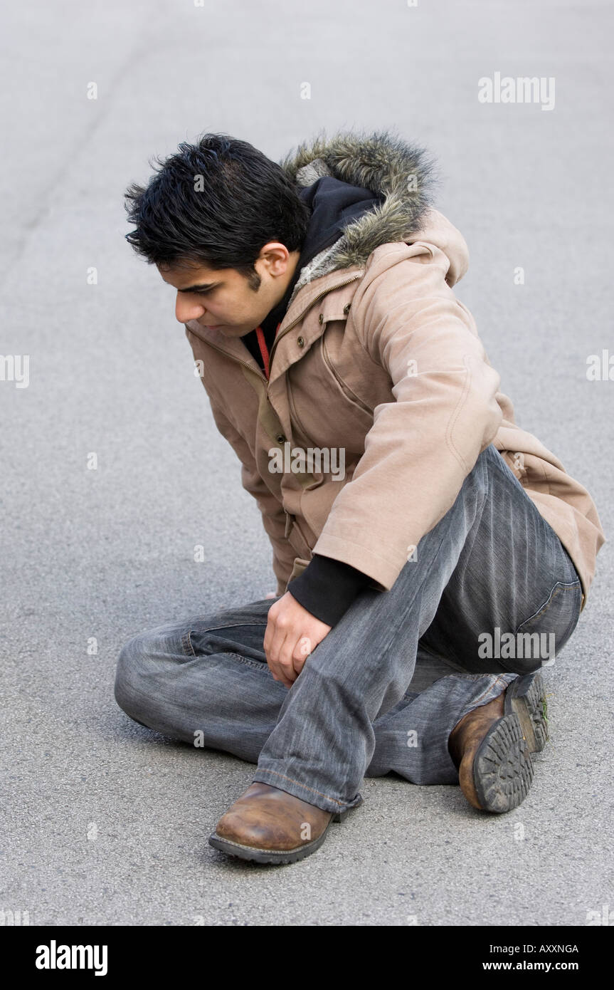 sad man on the ground Stock Photo - Alamy