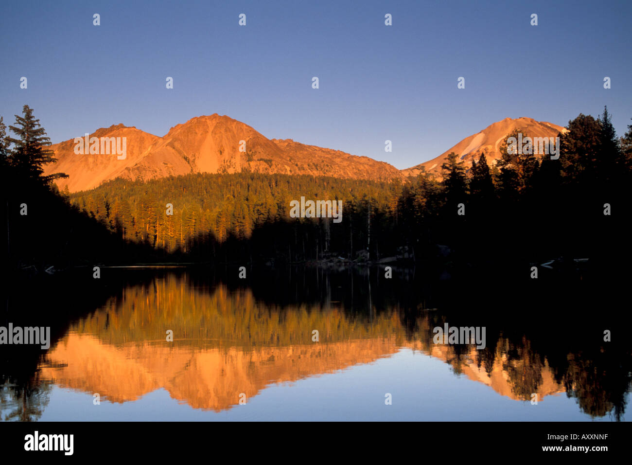 Sunset light on Chaos Crags reflected in Reflection Lake Lassen Volcanic National Park Shasta County California Stock Photo