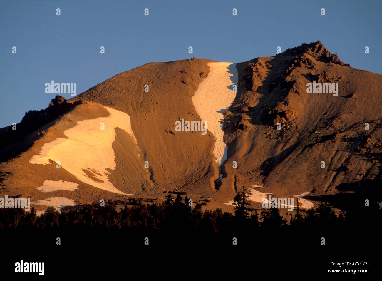 Morning sunrise light on the east face of volcano mountain summit Lassen Volcanic National Park California Stock Photo