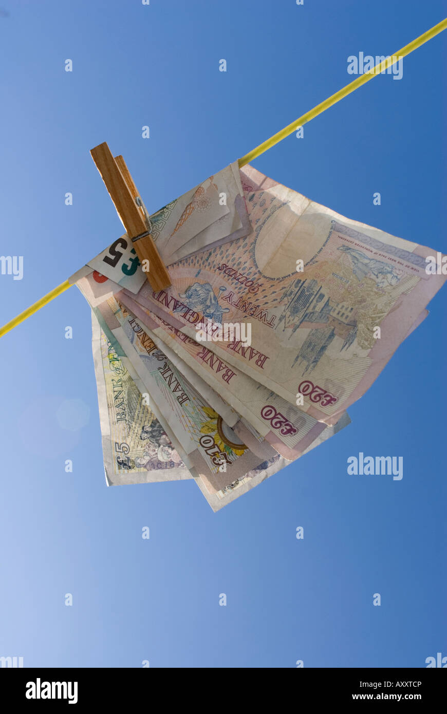 Washing Line Notes ten and twenty pound notes on a washing line in sunshine with blue sky ...