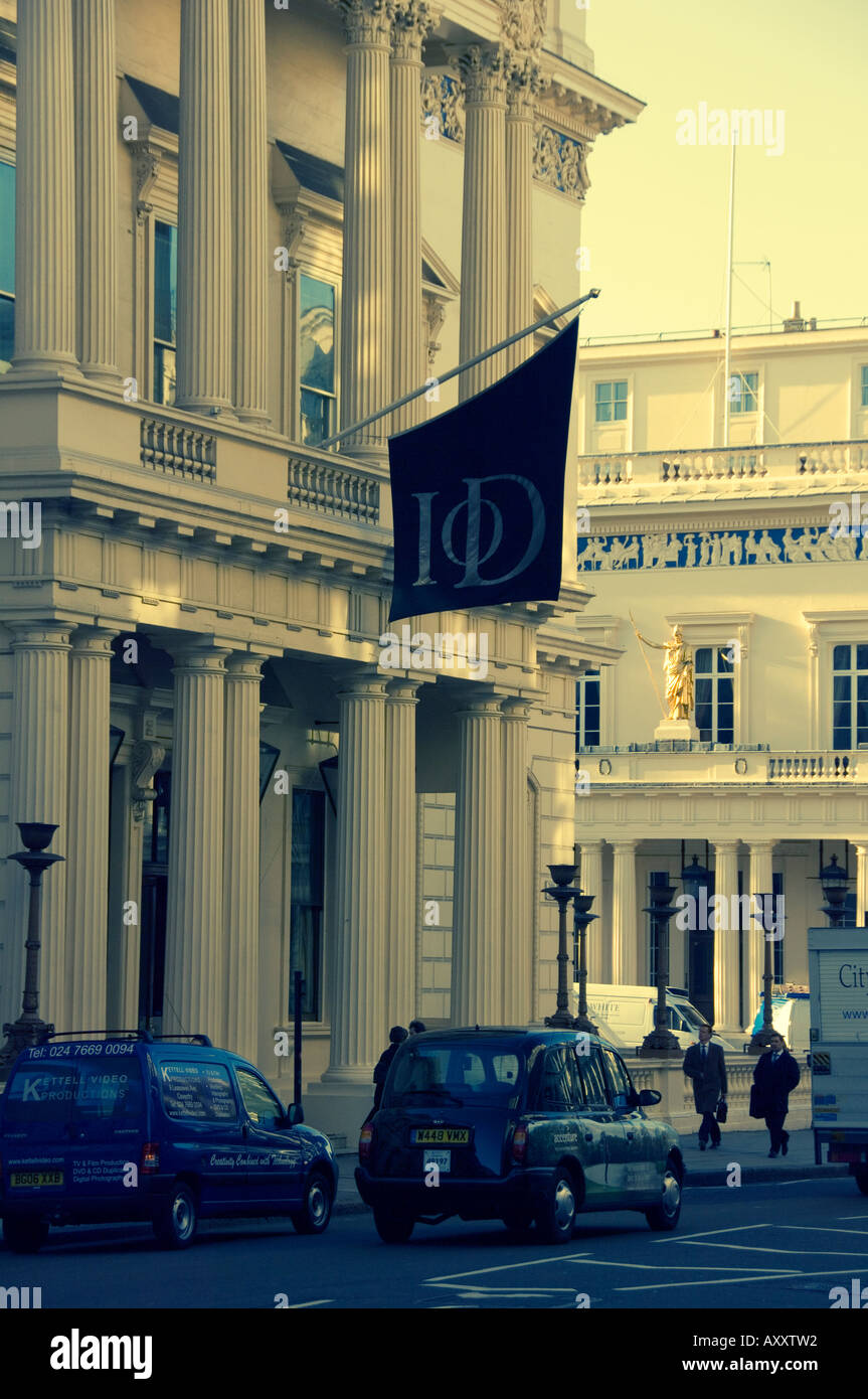 Banner and black taxi outside the Institute of Directors on Pall Mall, central London Stock Photo