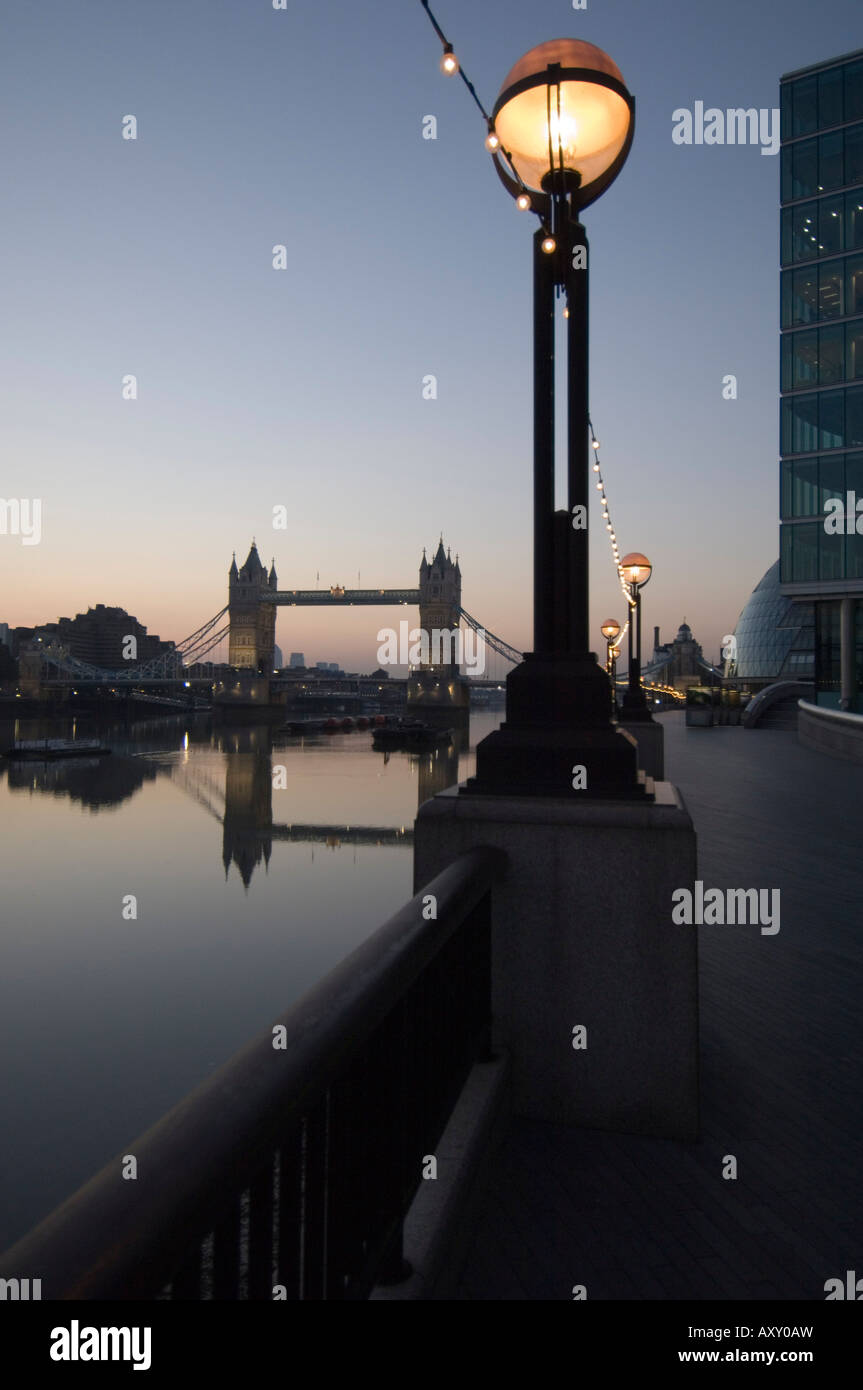 Tower Bridge reflected in the calm water of the River Thames in the early morning, London, England, United Kingdom, Europe Stock Photo
