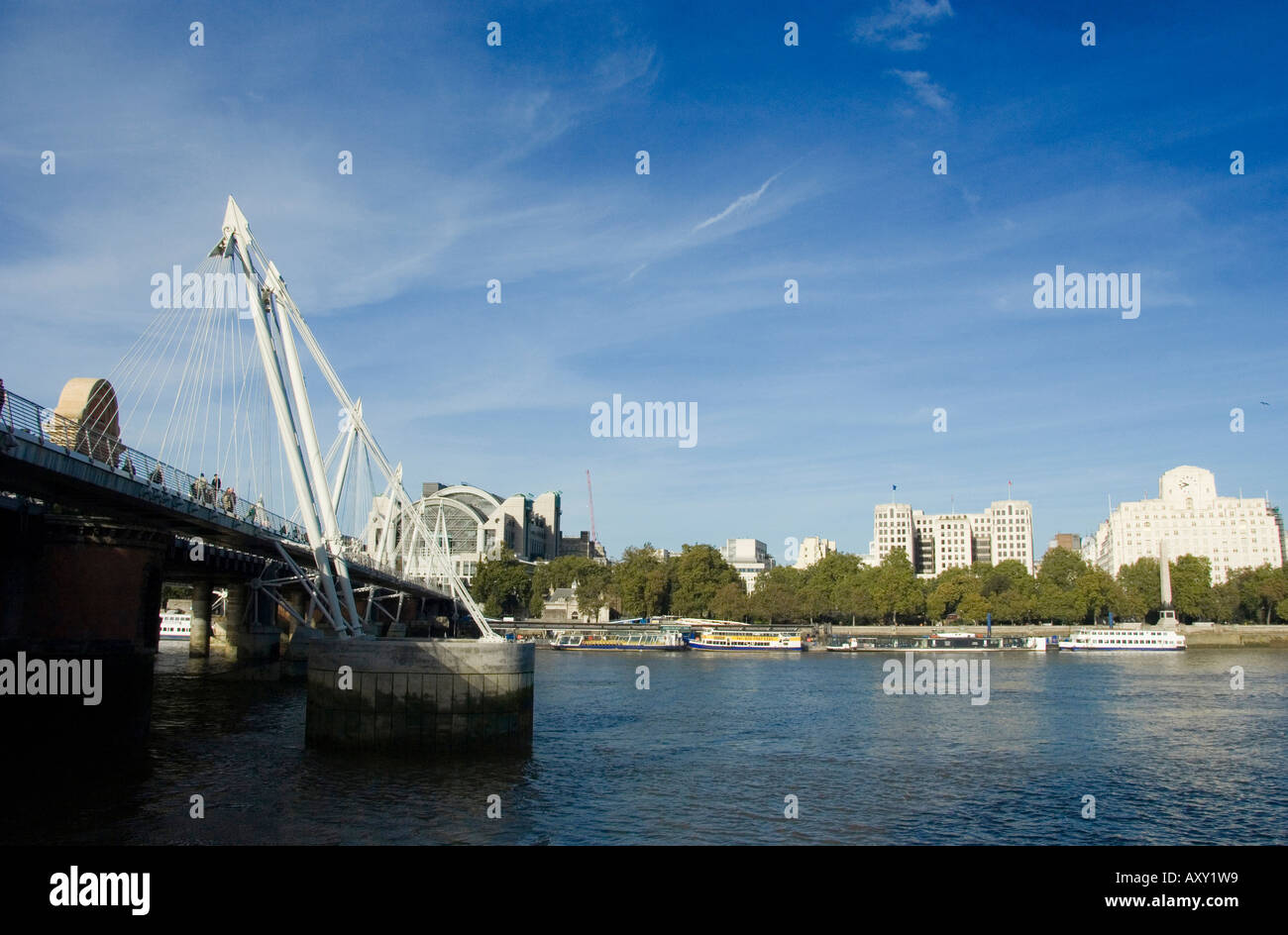 The river Thames in central London with the Golden Jubilee Footbridge to the left, looking
