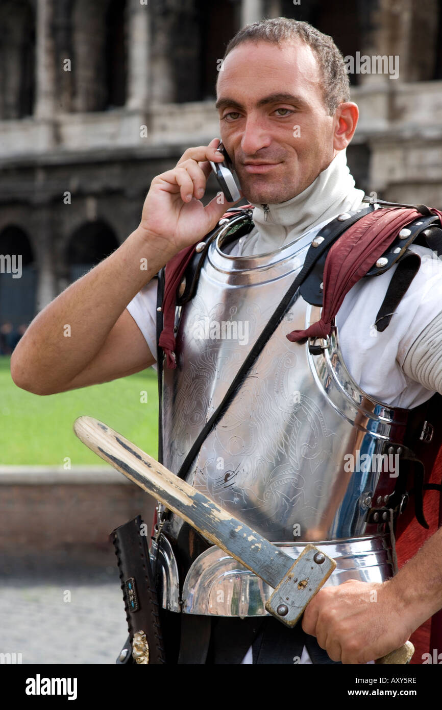 Model released portrait of man dressed as a gladiator and talking on a cell phone Stock Photo