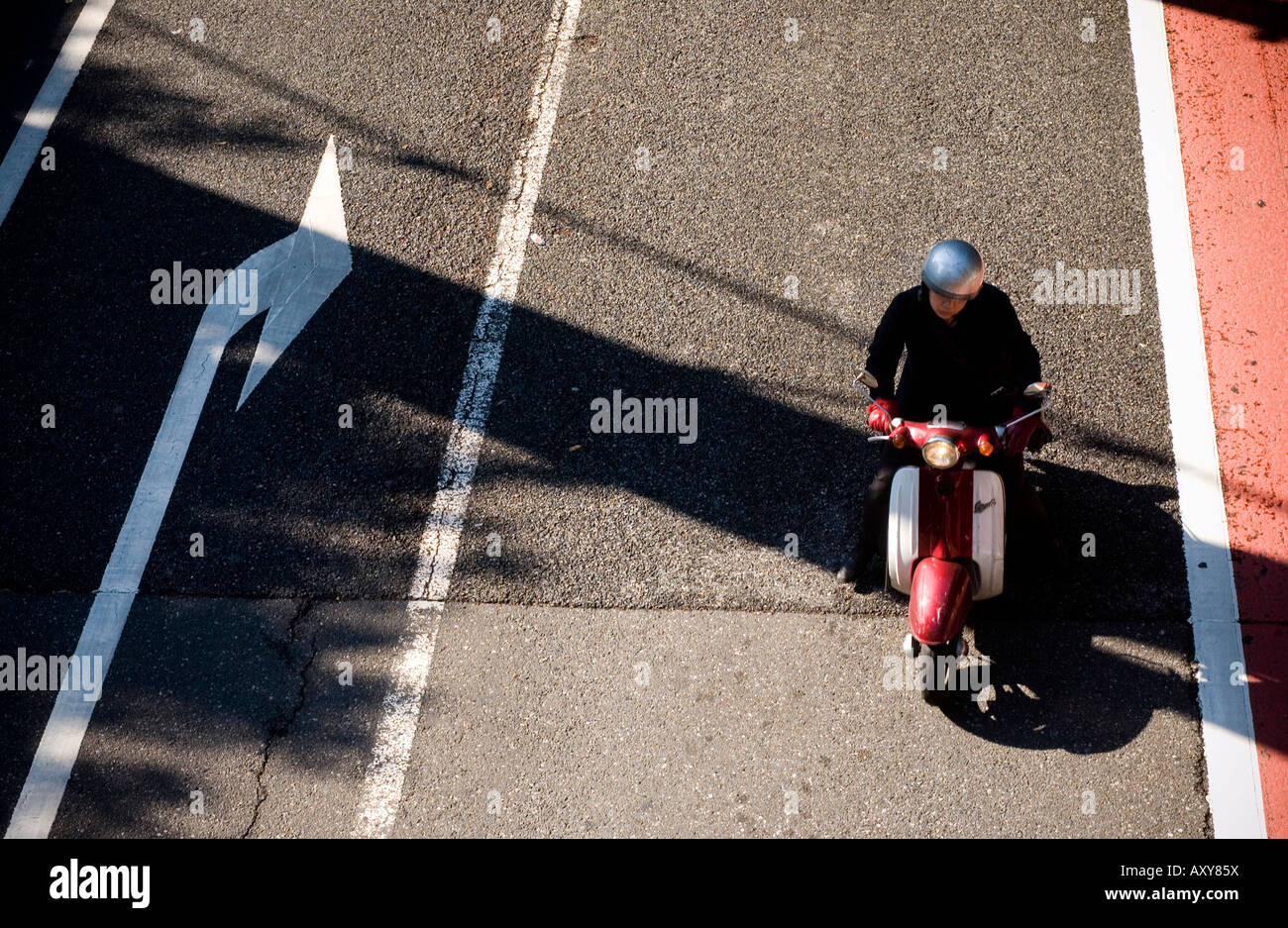 Overhead view of solo motor cyclist on road in Tokyo, Japan Stock Photo