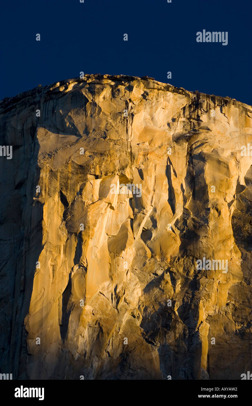 Golden sunrise light on sheer granite wall cliff face of El Capitan