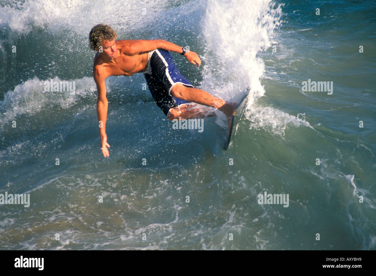 Surfer surfing on breaking wave using a skimboard near Balboa Pier Balboa Island Newport Beach California Stock Photo