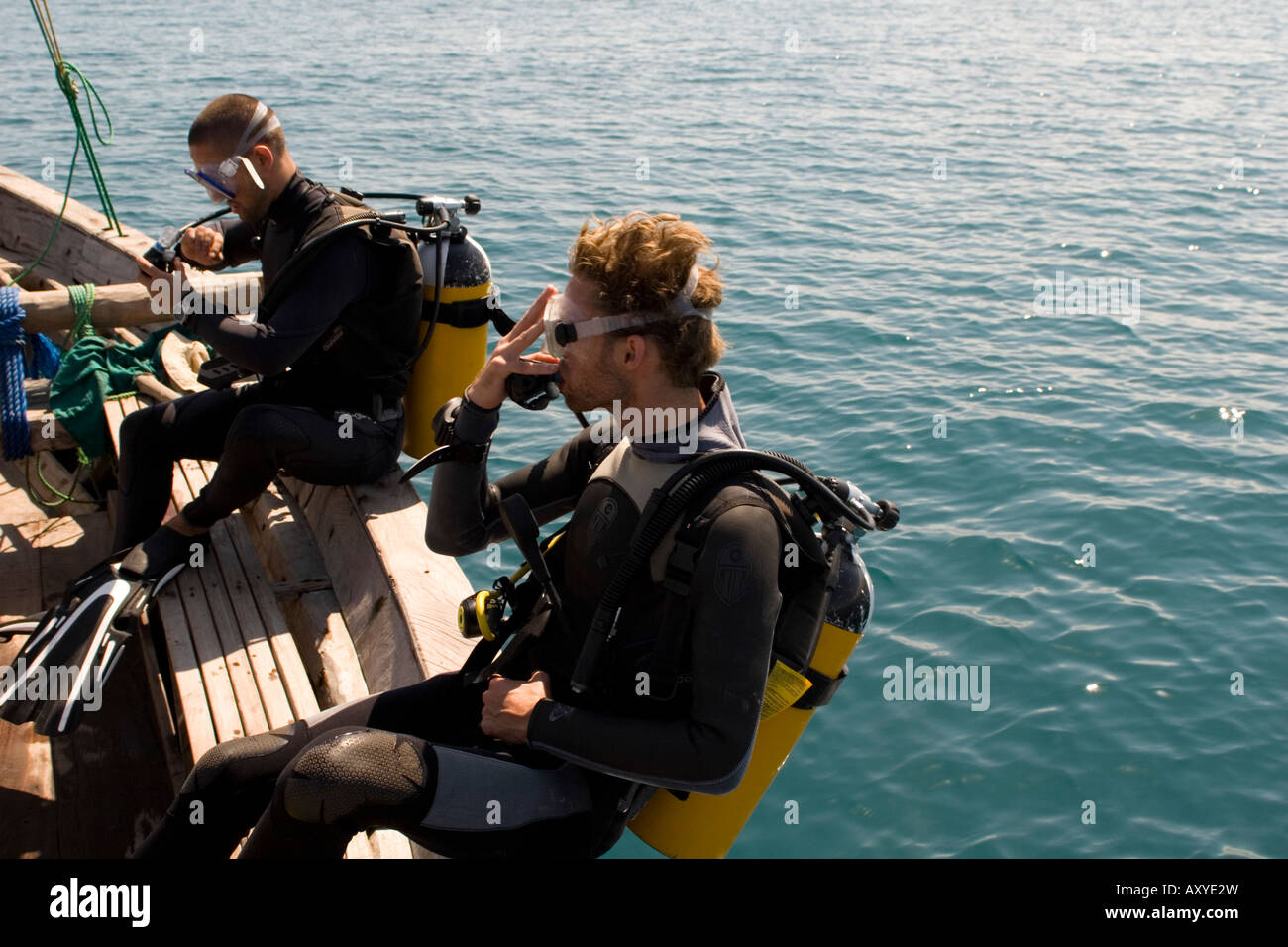 Scuba divers entering water from boat Chole Bay off Mafia Island