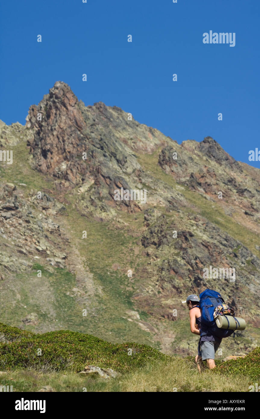 Hiker on climbing trail in hiking area of Pic de Coma Pedrosa, Andorra's highest mountain, Parish of La Massana, Andorra Stock Photo