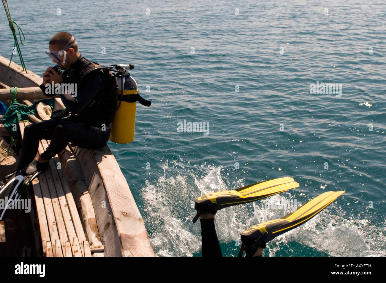 Scuba divers entering water from boat Chole Bay off Mafia Island