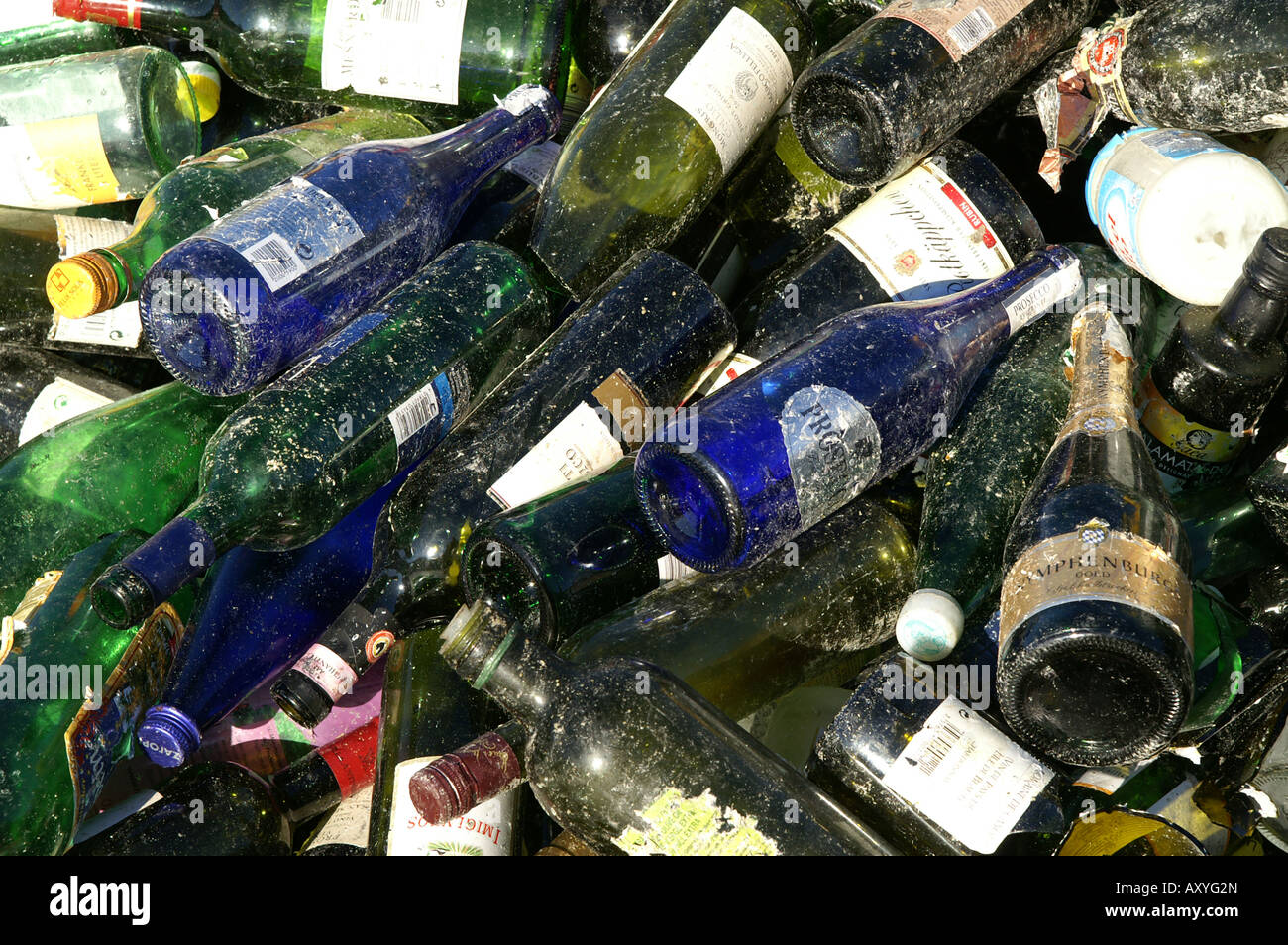 Old green and blue glass bottles at recycling plat / Grüne und blaue Altglasflaschen in Sammelstelle Stock Photo