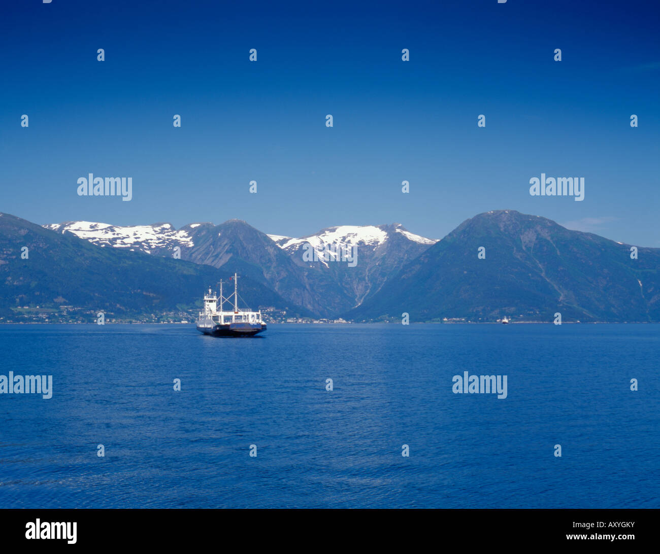 Car and passenger ferryboat on Sognefjord with Balestrand beyond, seen
