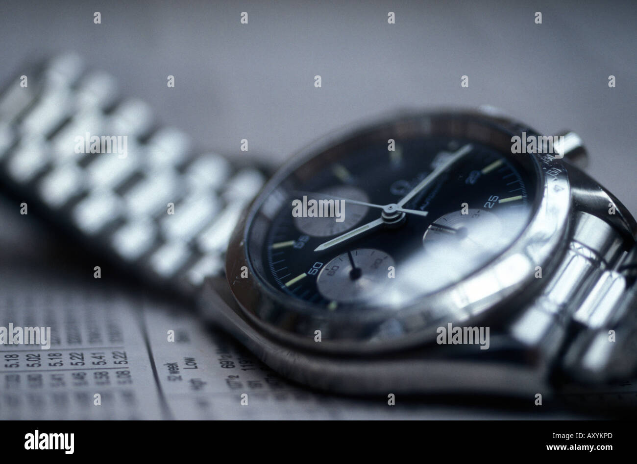 Wrist watch laying on financial page of newspaper Stock Photo