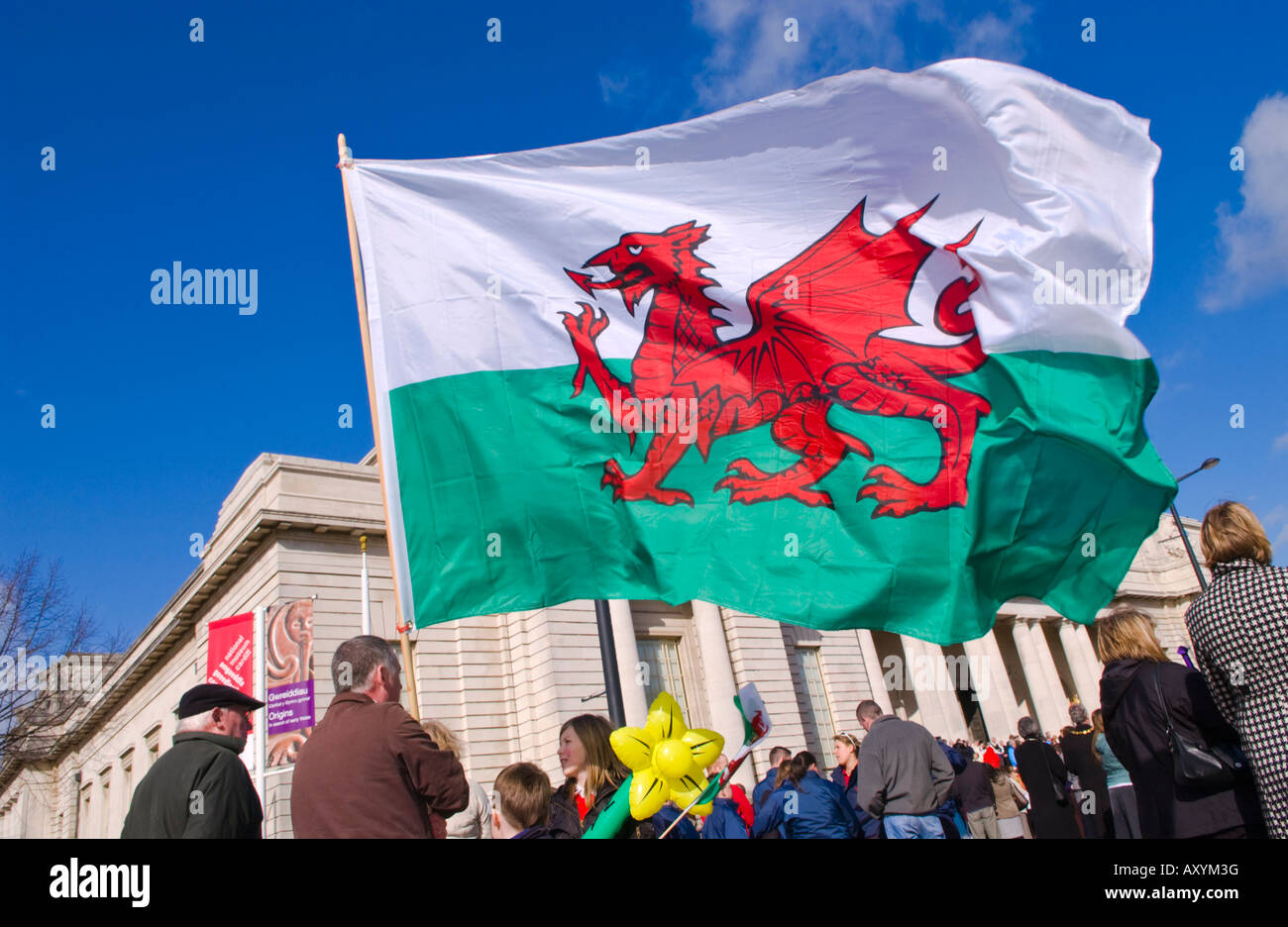 Welsh flag Crowd outside National Museum of Wales for annual St Davids Day march in Cardiff South Wales UK Stock Photo