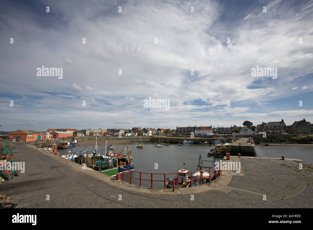 Port Seton Harbour under blue and cloudy summer skies. East Lothian